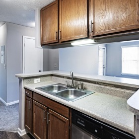 a kitchen with wooden cabinets