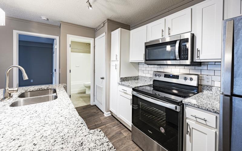 a kitchen with white cabinets