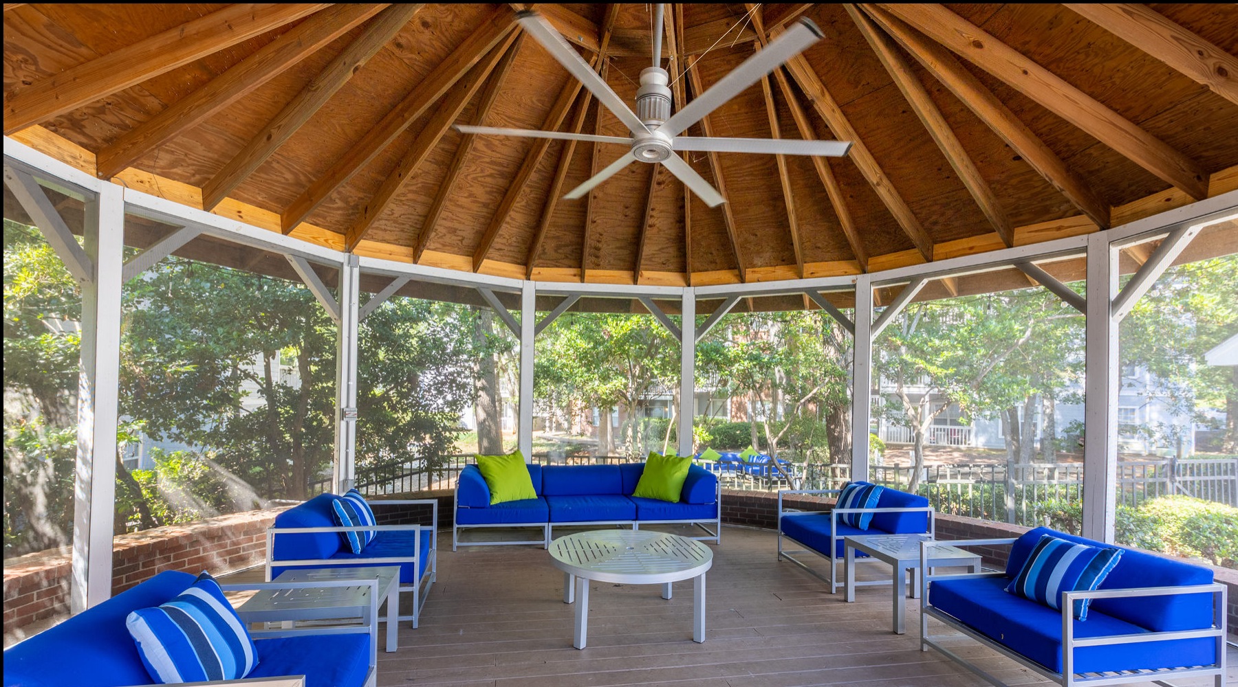 a gazebo with blue chairs